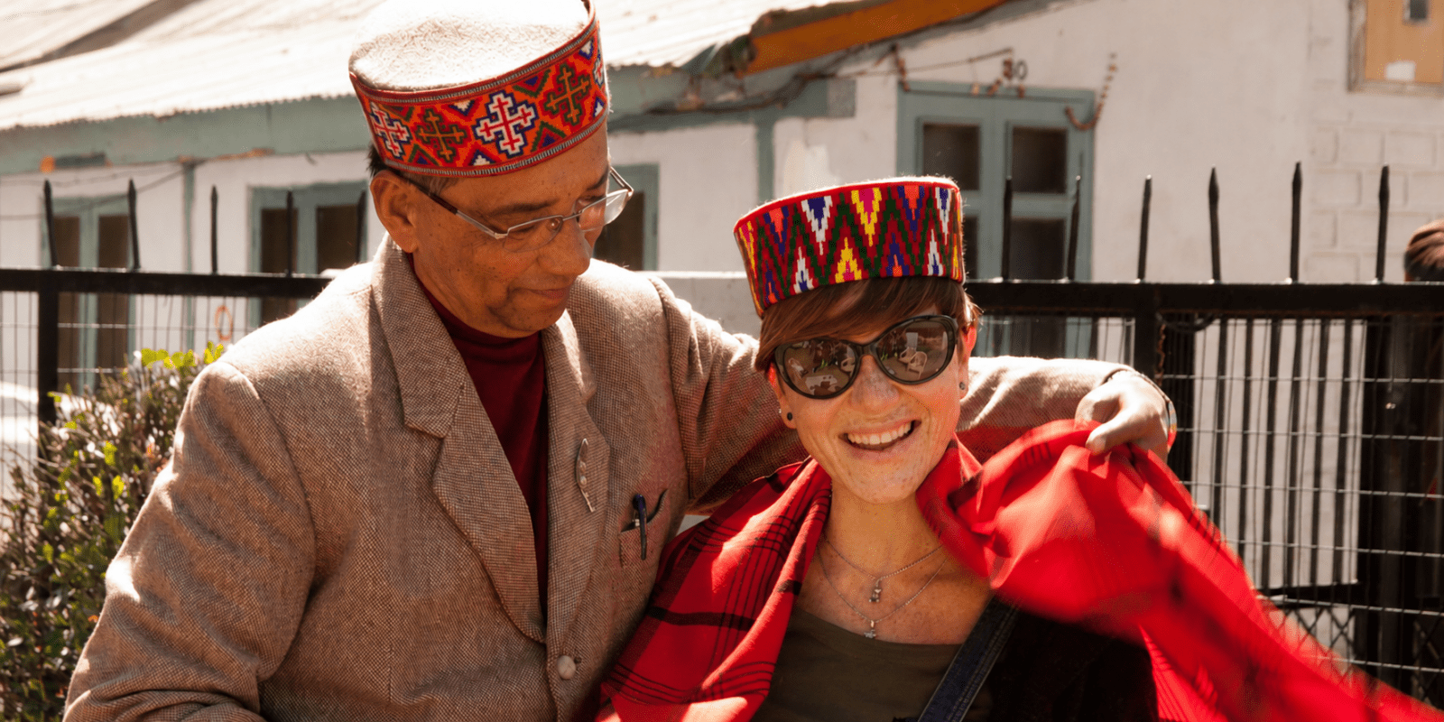 Nicky Taylor-East wearing a red handwoven shawl during a visit to the Kullu Valley weaving cooperative