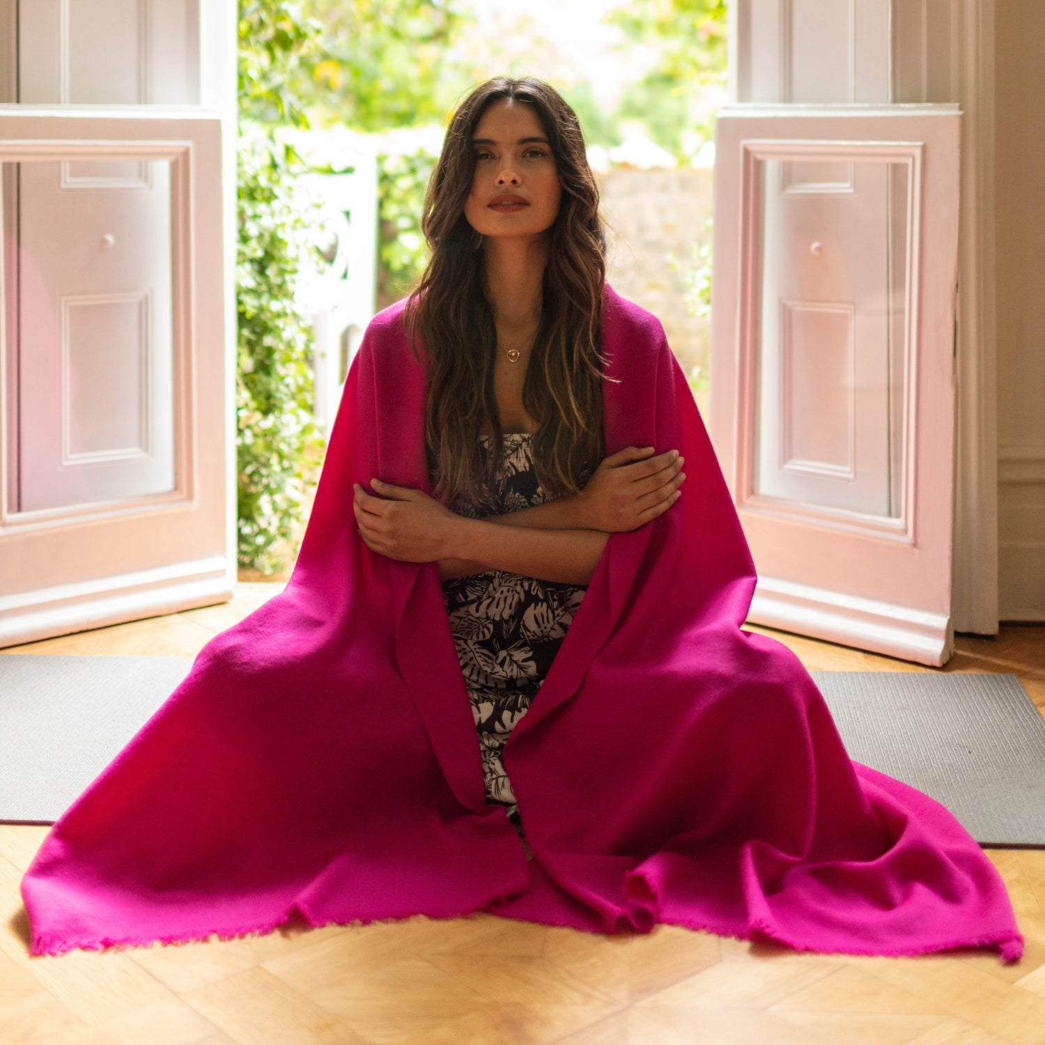 Pink wool blanket scarf worn as a shawl