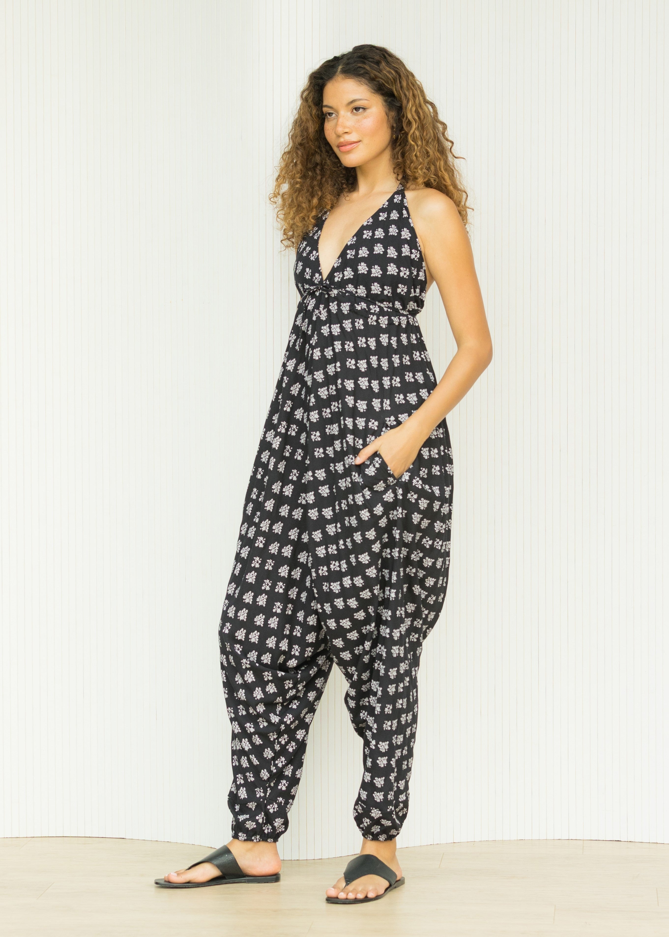 Black Fleurs halter harem jumpsuit with pockets and open back